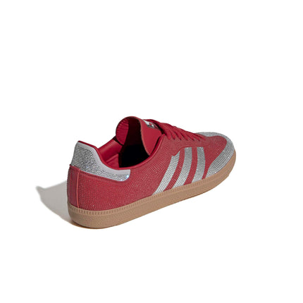 Adidas Women's Samba OG sneaker in red with a crystal-embellished upper, silver signature stripes, and a gum sole.