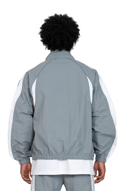 Back view of an EPTM Legacy Jacket in matte grey nylon featuring white side panels worn over a white undershirt.