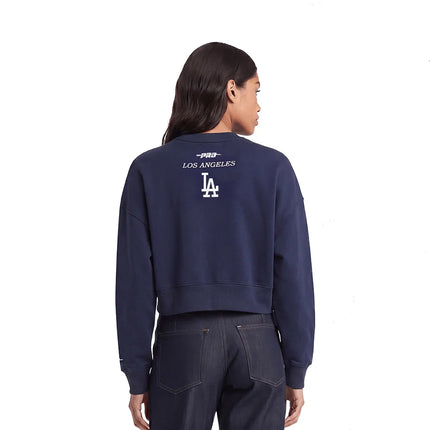 Person wearing a navy blue sweatshirt with 'Los Angeles' text and logo on the back, standing against a white background.