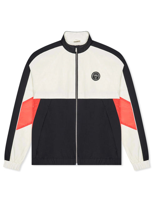 Malbon Axis jacket in cream, black, and bright orange with a zip-front closure and a circular logo patch on the chest.