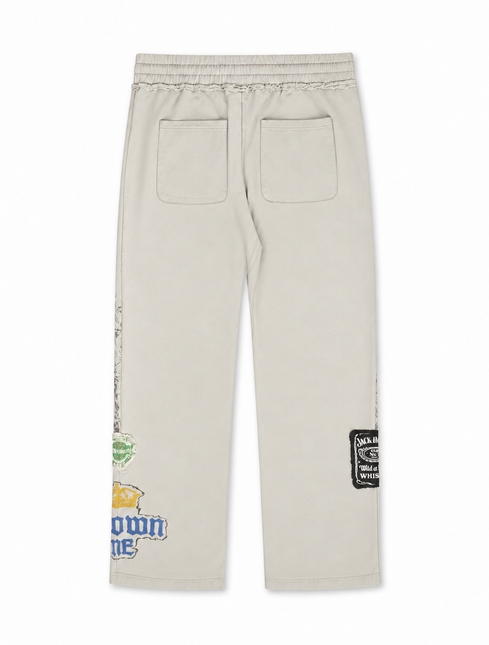 Rebel Minds Jack of All Trades joggers in light grey cotton with vintage brand patches on the back of the pant legs.