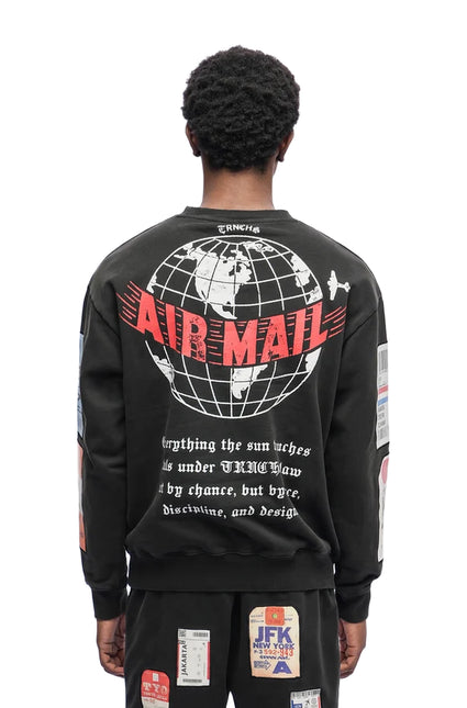 Black Trnchs Airmail crewneck sweater featuring a white globe graphic, red Airmail text, and vintage postal prints.