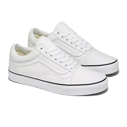 Pair of white leather Vans Old Skool sneakers featuring a low-top silhouette with a signature side stripe and sole.