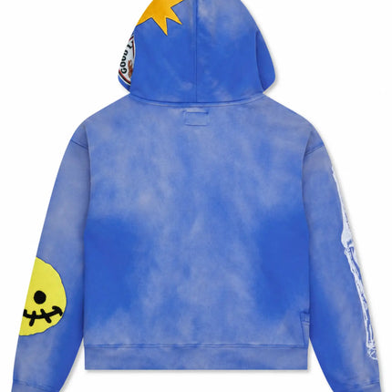 All Human El Perro V2 blue wash cotton hoodie featuring a yellow star, smiley face patch, and skeletal sleeve print.