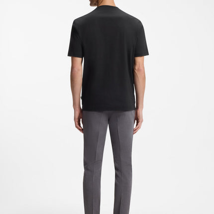 Back view of a man wearing a black Hugo Boss Double-B monogram badge cotton t-shirt paired with grey slim trousers.