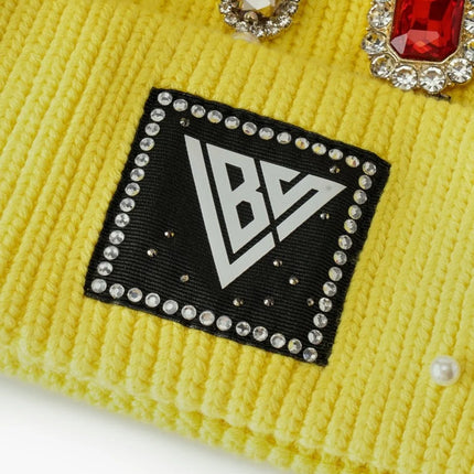 Yellow ribbed knit Valabasas beanie featuring a square logo patch accented with rhinestone trim and crystal gems.