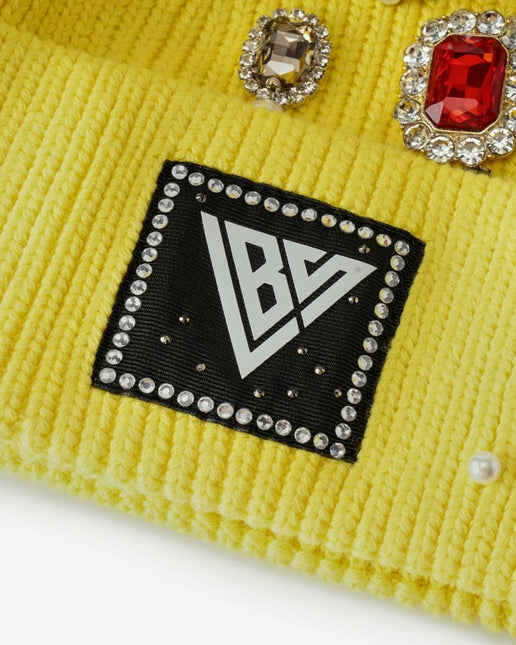 Yellow ribbed knit Valabasas beanie featuring a square logo patch accented with rhinestone trim and crystal gems.
