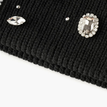 Black ribbed knit Valabasas beanie adorned with various clear and red faceted gemstone embellishments and crystals.