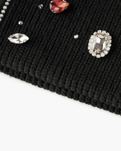 Black ribbed knit Valabasas beanie adorned with various clear and red faceted gemstone embellishments and crystals.