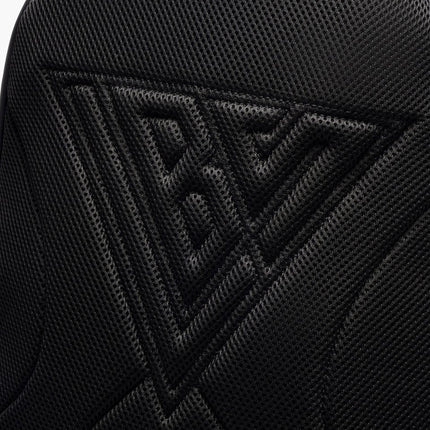 Close-up view of the black Valabasas La Borsa backpack featuring a triangular mesh texture embossed with a logo.