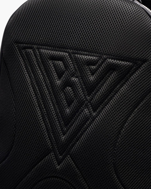 Close-up view of the black Valabasas La Borsa backpack featuring a triangular mesh texture embossed with a logo.