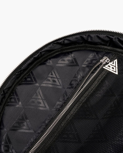 Close-up of a black Valabasas backpack interior featuring a repeating geometric logo pattern and a silver zipper.