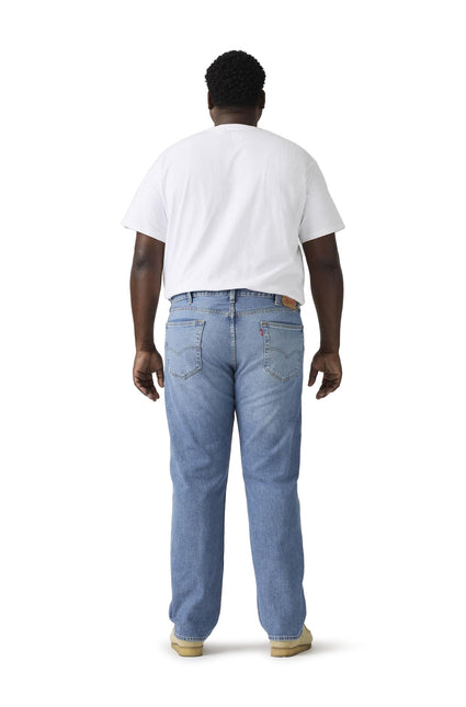 Back view of a person wearing Levi’s 501 Big and Tall original fit denim jeans in a light blue washed finish.